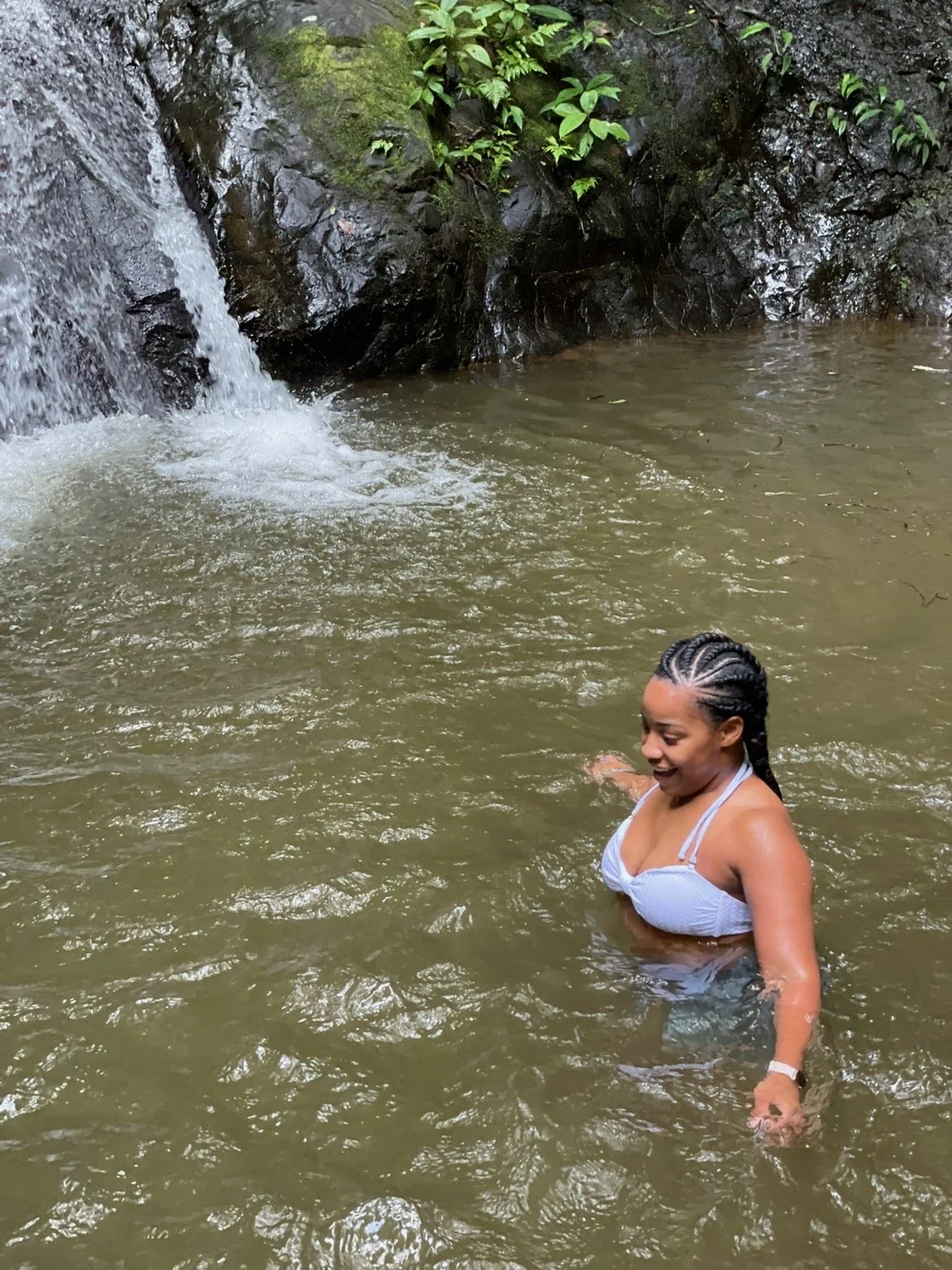 A traveler at a waterfall in Costa Rica